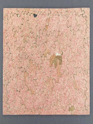 57 PIECE JIGSAW PUZZLE, LATE 18TH CENTURY, DEPICTING A PICNIC SCENE OF FIVE ARISTOCRATIC CHARACTERS IN GEORGIAN STYLE DRESS PREPARING TO PICNIC ON SHORE. A BLACK SERVANT OR SLAVE IS IN THE ROWBOAT WHICH IS TIED TO THE TREE ON SHORE; HE IS HANDING A BOTTLE TO ONE OF THE MEN. ONE MAN IS SEATED ON THE GROUND WHILE HIS LADY IS SEATED ON A CHAIR BY HIS SIDE. A SECOND MAN IS SETTING UP A CHAIR FOR HIS LADY.